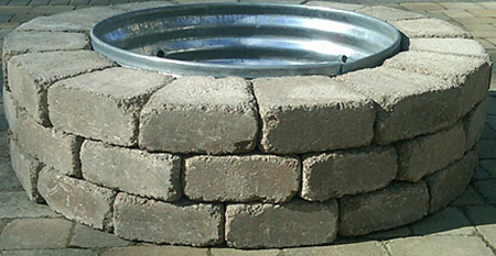 30 inch reading rock firepit with pewter color stones and a round sheet metal lining.