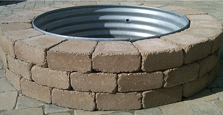 42 inch reading rock firepit with rustic rock stones and a round sheet metal lining.