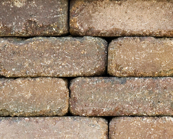 Rustic Rock concrete stone pieces that are a dark brown color used in a firepit kit sold at Westview Concrete.
