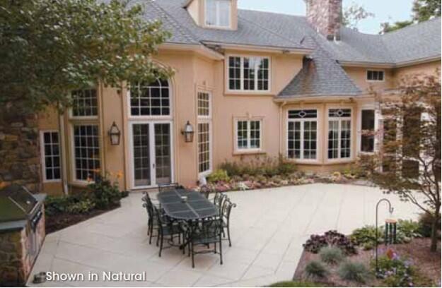 Image of a homes white colored patio  that is built with Hanover Prest Concrete Pavers with a patio table and chairs.
