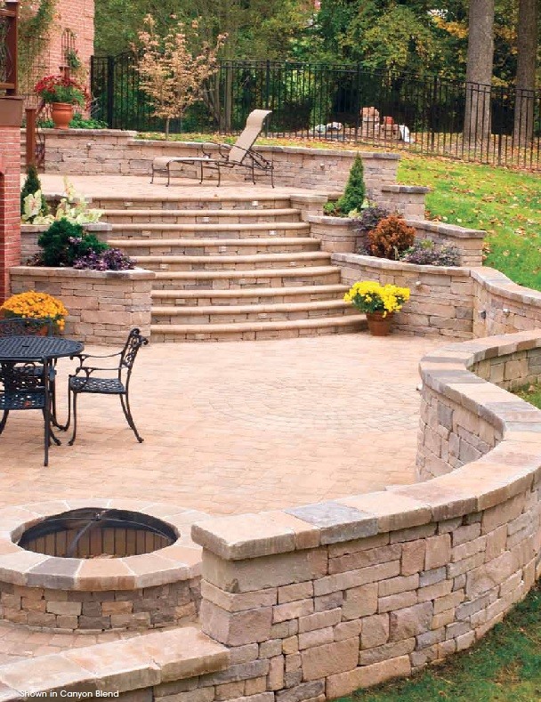Image of a backyard patio and Garden Wall built with Hanover Pavers Chapel Stone® sold by Westview Concrete.