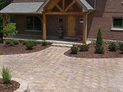 Image of a front drive and walkway of a home built with Oxford Tumbled Series Concrete Pavers sold by Westview Concrete Corp