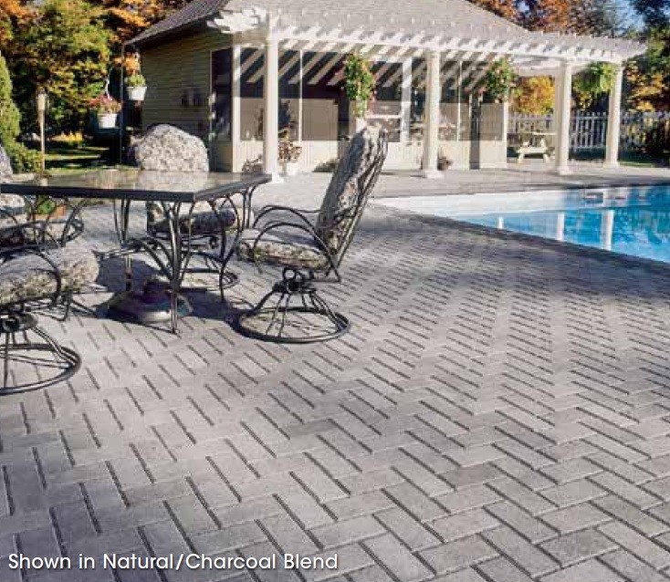 Image of a backyard patio and pool that has traditional 4" X 8" Bricks By Hanover Pavers installed. Bricks provided by Westview Concrete Corp